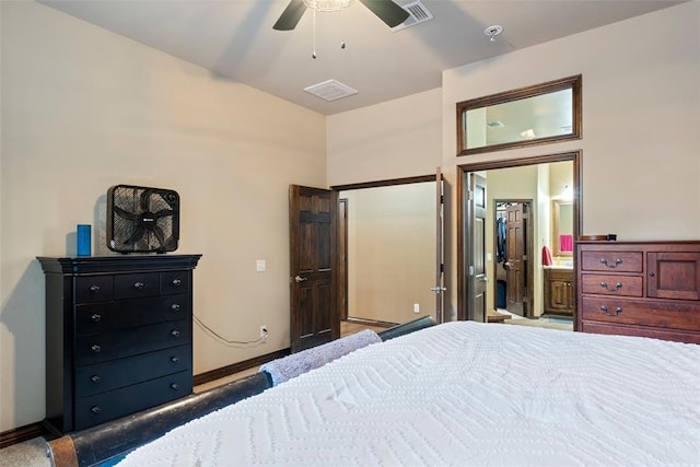 carpeted bedroom with ceiling fan and ensuite bath