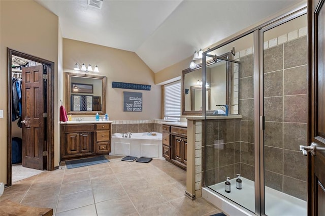 bathroom with tile patterned flooring, vanity, lofted ceiling, and plus walk in shower