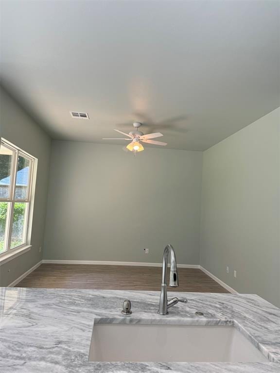 kitchen featuring hardwood / wood-style flooring, sink, and ceiling fan