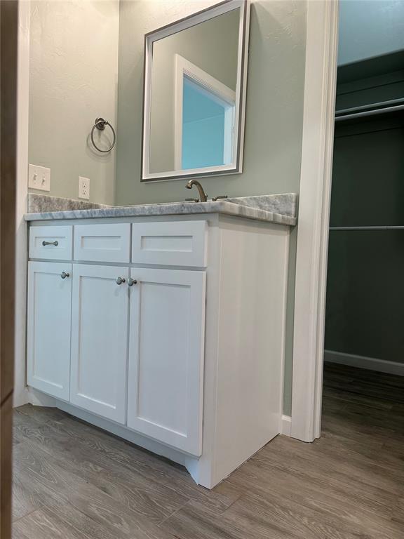 bathroom with vanity and hardwood / wood-style flooring