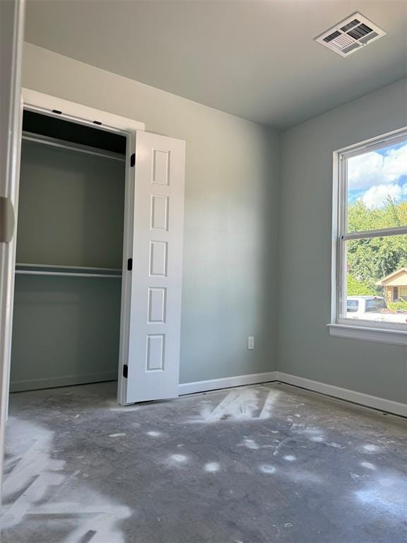 unfurnished bedroom featuring concrete floors