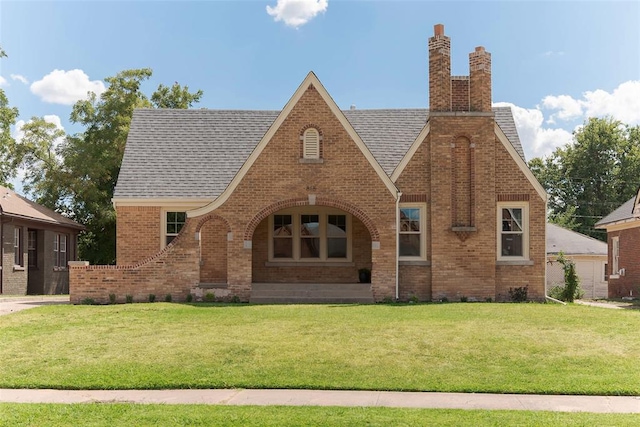 tudor house featuring a front yard