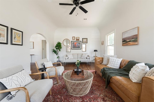 living room with ceiling fan and dark hardwood / wood-style flooring