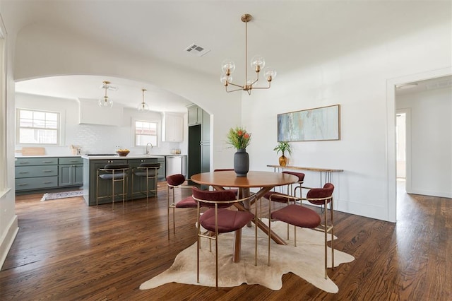 dining space featuring a chandelier, dark hardwood / wood-style floors, plenty of natural light, and sink