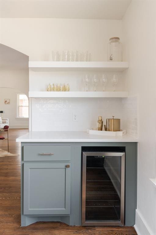 bar featuring wine cooler and dark hardwood / wood-style floors