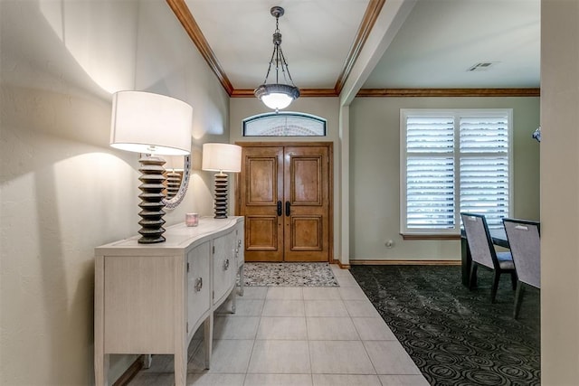 tiled foyer entrance with ornamental molding