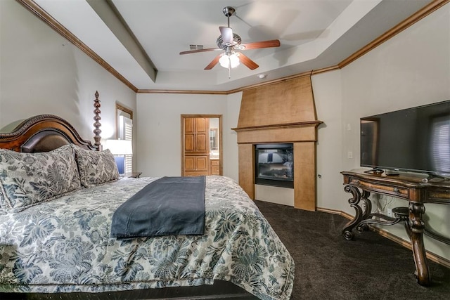 bedroom featuring carpet, ceiling fan, crown molding, and a tray ceiling