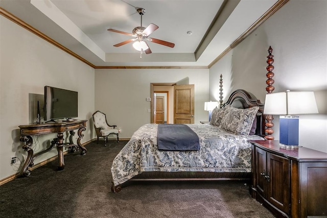 bedroom featuring a raised ceiling, ceiling fan, dark carpet, and ornamental molding