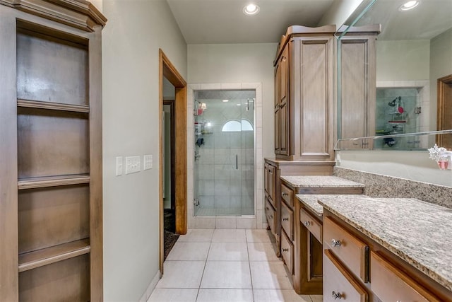 bathroom with tile patterned floors, vanity, and walk in shower