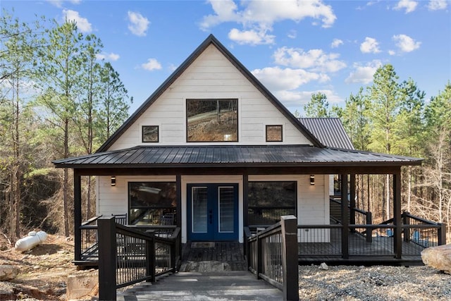 modern farmhouse with a porch and french doors