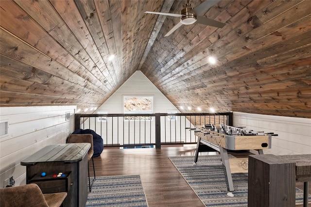 additional living space featuring ceiling fan, dark hardwood / wood-style floors, wood walls, lofted ceiling, and wood ceiling