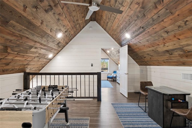 recreation room with ceiling fan, wooden ceiling, dark hardwood / wood-style floors, wood walls, and vaulted ceiling