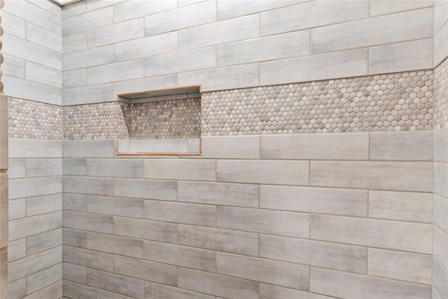 bathroom with a tile shower