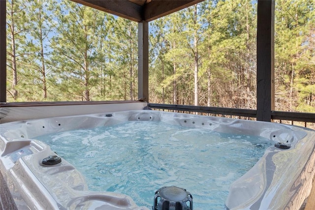 unfurnished sunroom featuring a jacuzzi