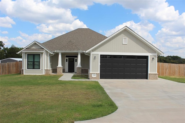 craftsman-style house with a garage and a front lawn