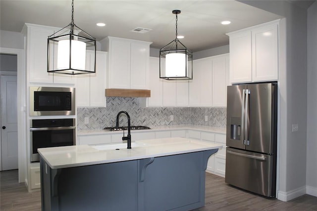 41208 Hazel Dell Rd, Shawnee, OK 74804 - kitchen featuring appliances with stainless steel finishes, tasteful backsplash, dark wood finished floors, light countertops, and recessed lighting