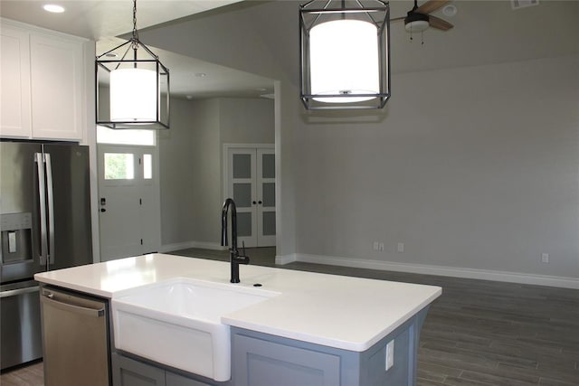 41208 Hazel Dell Rd, Shawnee, OK 74804 - kitchen with appliances with stainless steel finishes, light countertops, dark wood-style floors, hanging light fixtures, and a ceiling fan
