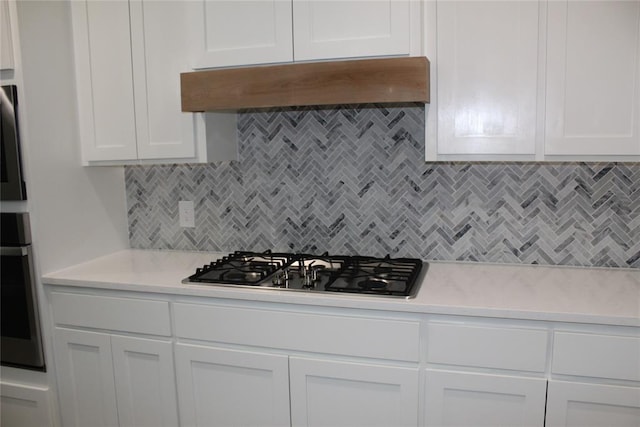 41208 Hazel Dell Rd, Shawnee, OK 74804 - kitchen with custom exhaust hood, light countertops, stainless steel appliances, and white cabinets