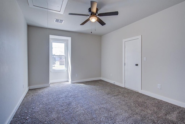 empty room featuring ceiling fan and carpet