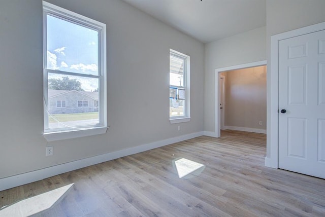 spare room with light hardwood / wood-style flooring