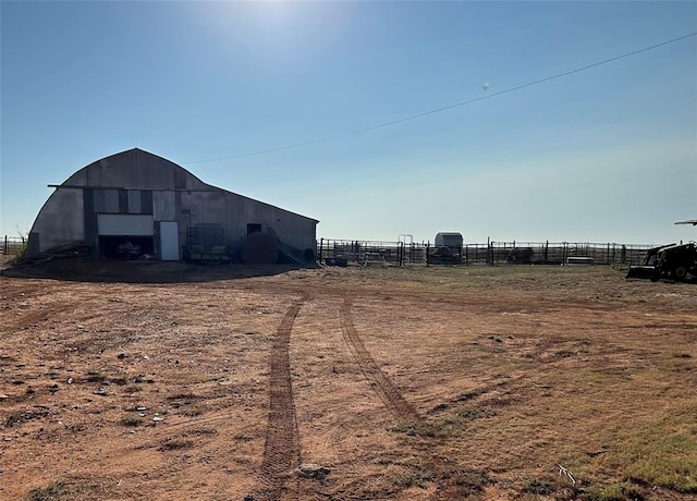 view of yard with an outbuilding and a rural view