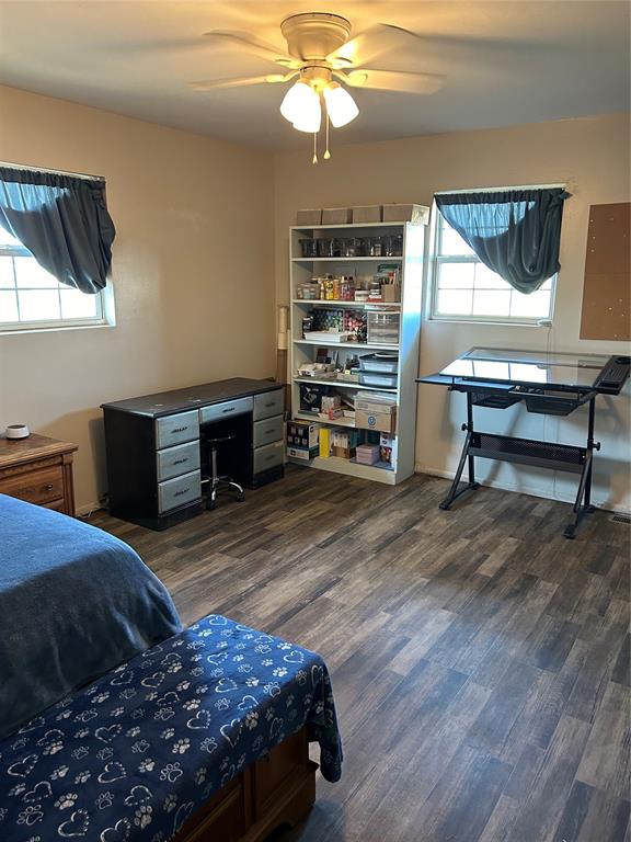 bedroom with ceiling fan and dark wood-type flooring