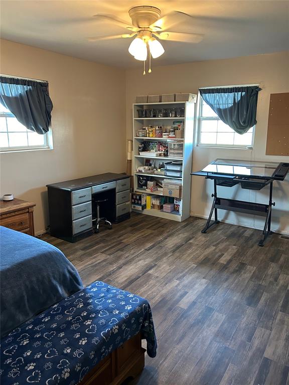 bedroom with ceiling fan and dark hardwood / wood-style flooring