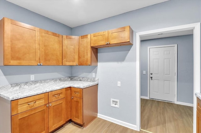 kitchen featuring light stone counters and light hardwood / wood-style floors