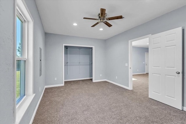 unfurnished bedroom with carpet floors, a closet, and ceiling fan