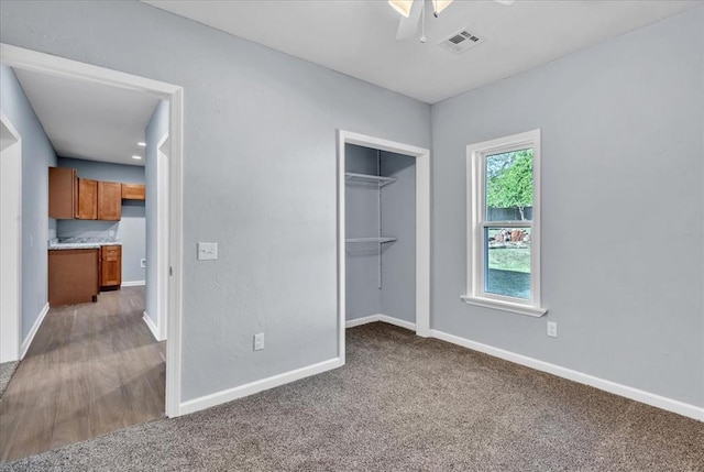 unfurnished bedroom featuring ceiling fan, carpet floors, and a closet