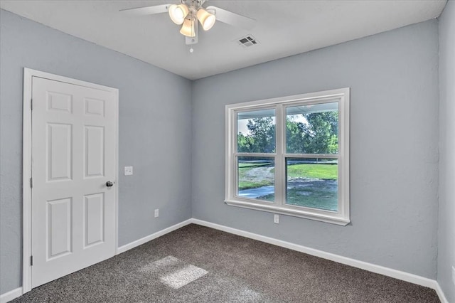 empty room with ceiling fan and carpet floors