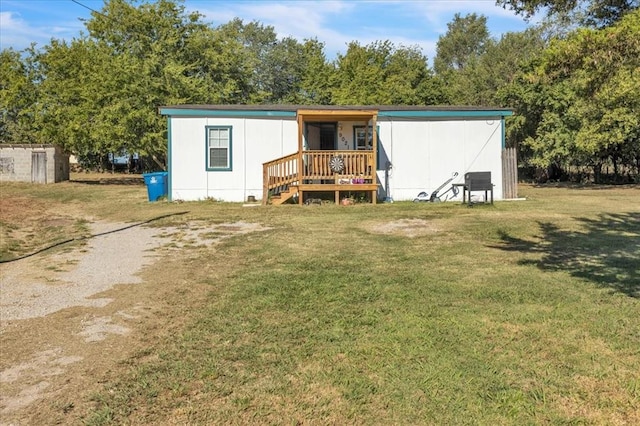 rear view of house with a yard and covered porch