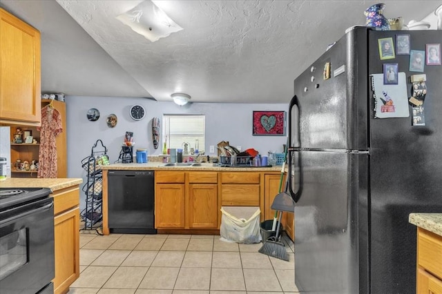 kitchen featuring light tile patterned floors, sink, a textured ceiling, and black appliances