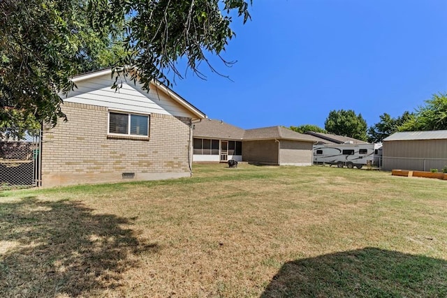 rear view of property with a lawn