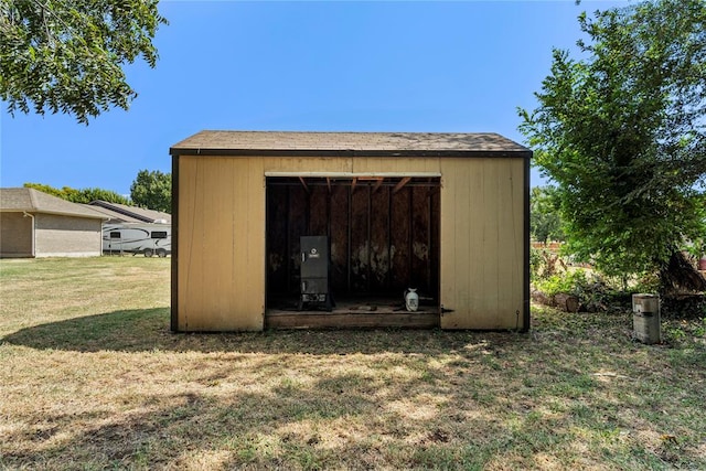 view of outdoor structure featuring a lawn