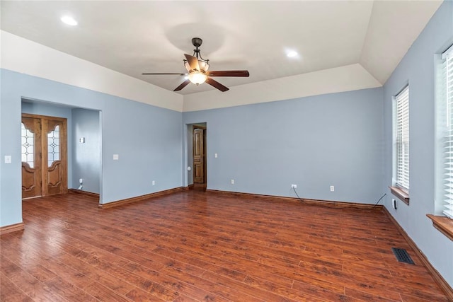 empty room with dark hardwood / wood-style floors, ceiling fan, and lofted ceiling