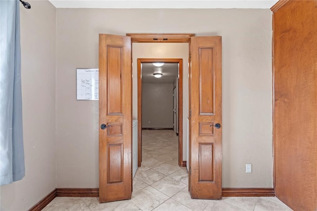 corridor with light tile patterned flooring