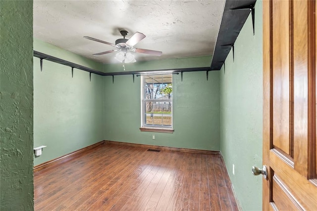 spare room featuring ceiling fan and dark hardwood / wood-style flooring