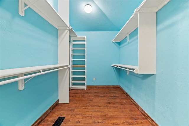 walk in closet featuring dark hardwood / wood-style flooring