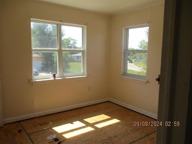 unfurnished room featuring plenty of natural light