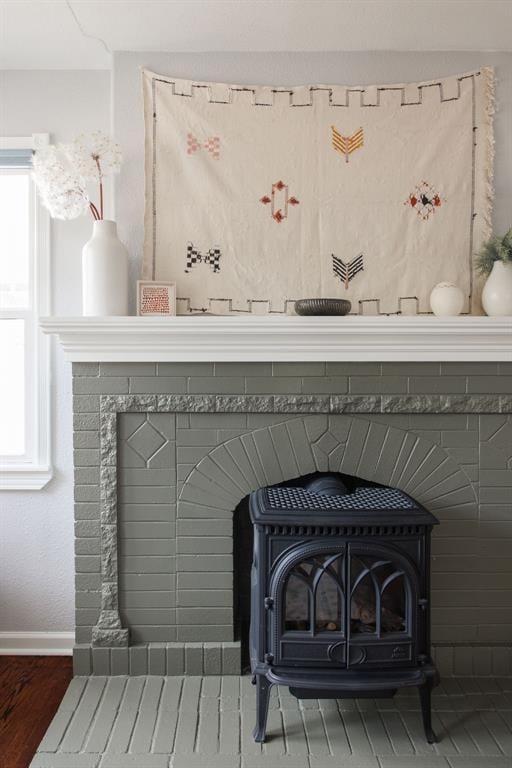 room details featuring hardwood / wood-style flooring and a wood stove