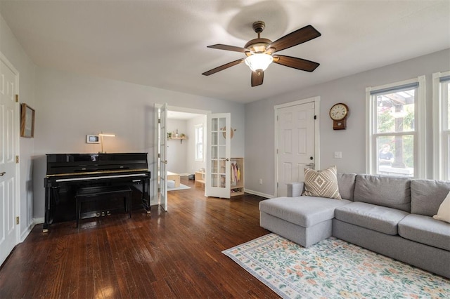 living room with ceiling fan, dark hardwood / wood-style flooring, and french doors