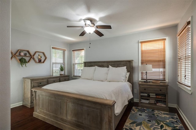 bedroom with ceiling fan and dark hardwood / wood-style flooring