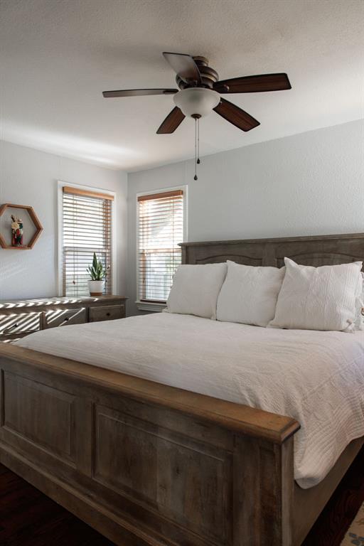 unfurnished bedroom featuring ceiling fan and dark wood-type flooring