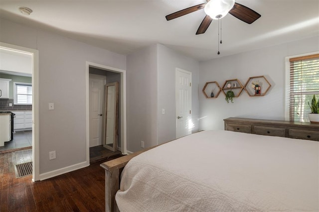 bedroom with ceiling fan and dark hardwood / wood-style flooring