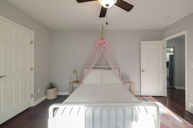 bedroom with ceiling fan and dark wood-type flooring