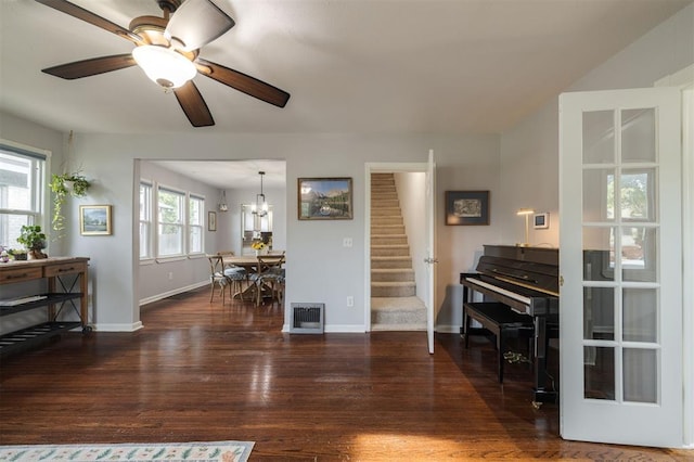 interior space featuring dark hardwood / wood-style flooring, plenty of natural light, and ceiling fan with notable chandelier