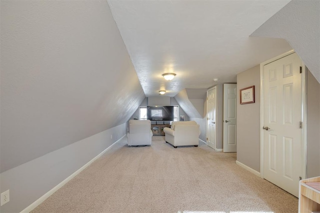 interior space with light colored carpet and lofted ceiling