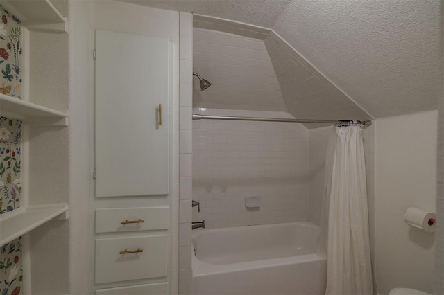 bathroom featuring lofted ceiling, a textured ceiling, and shower / tub combo