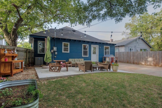 rear view of property with outdoor lounge area, a yard, a patio, and central AC unit